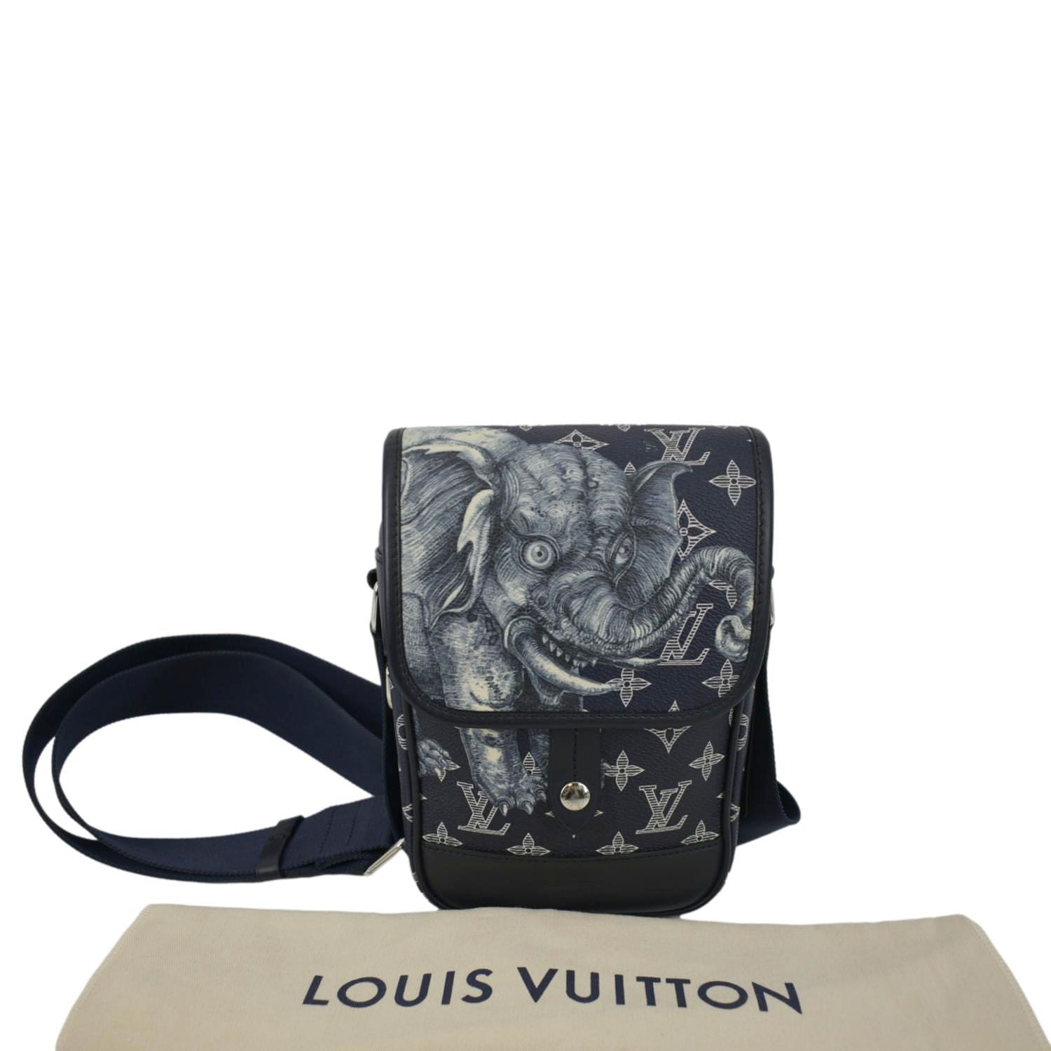 Man with blue leather Louis Vuitton backpack with elephant before